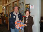 Jim, W4QO, presents library books to Lu Conti at the Roswell library